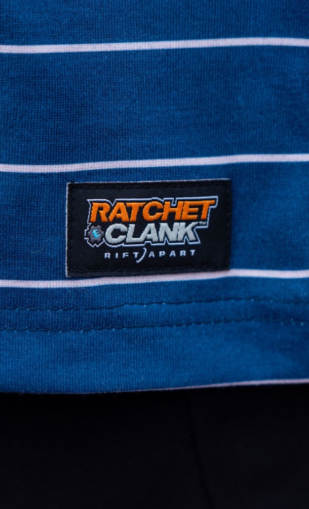 Close up detail on the logo patch of the Rivet Striped T-Shirt from our Ratchet & Clank collection