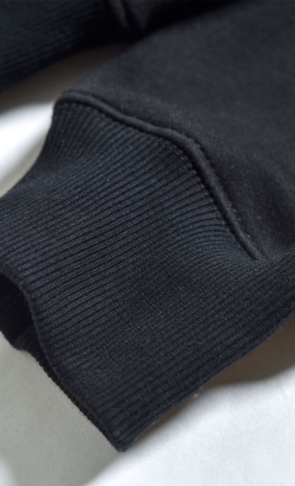Close up detail on the sleeve of the WASD hoodie from our WASD collection