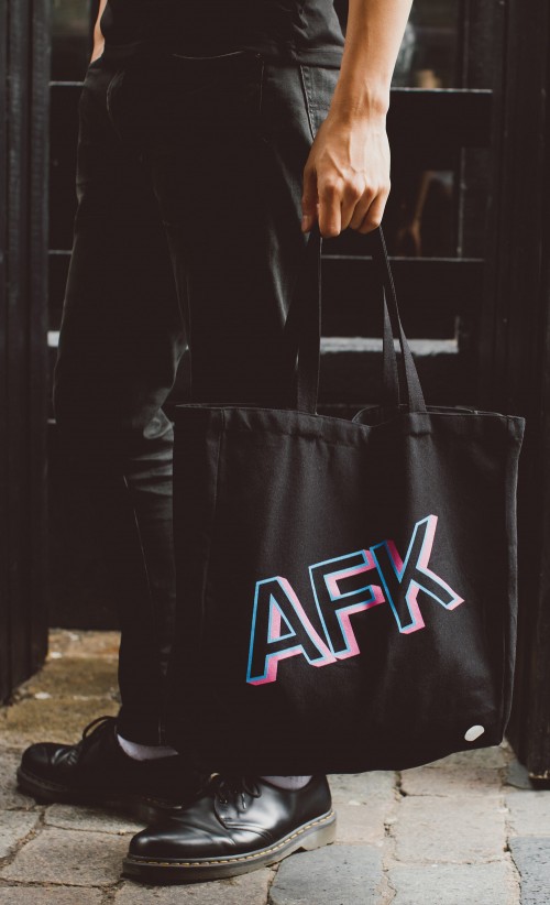Model carrying the AFK The bag from our Insert Coin collection