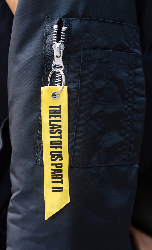 Close up detail on the arm tag of the Abby Bomber jacket from our The Last of Us collection