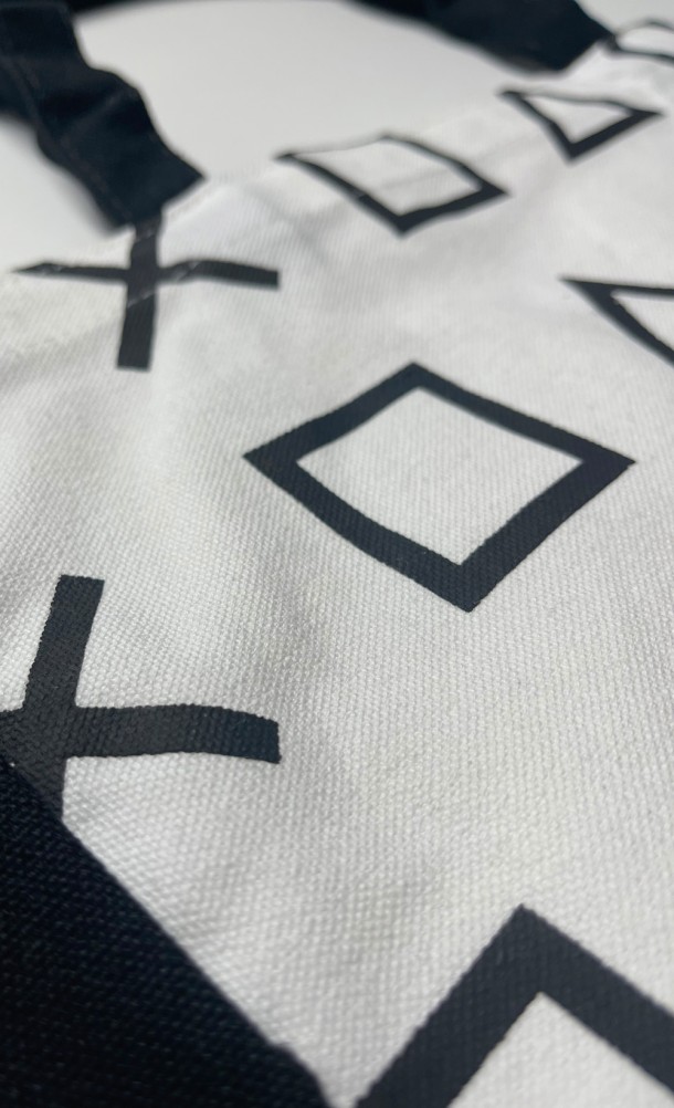 Close up detail on the front print of the DualSense Tote bag from our PlayStation collection