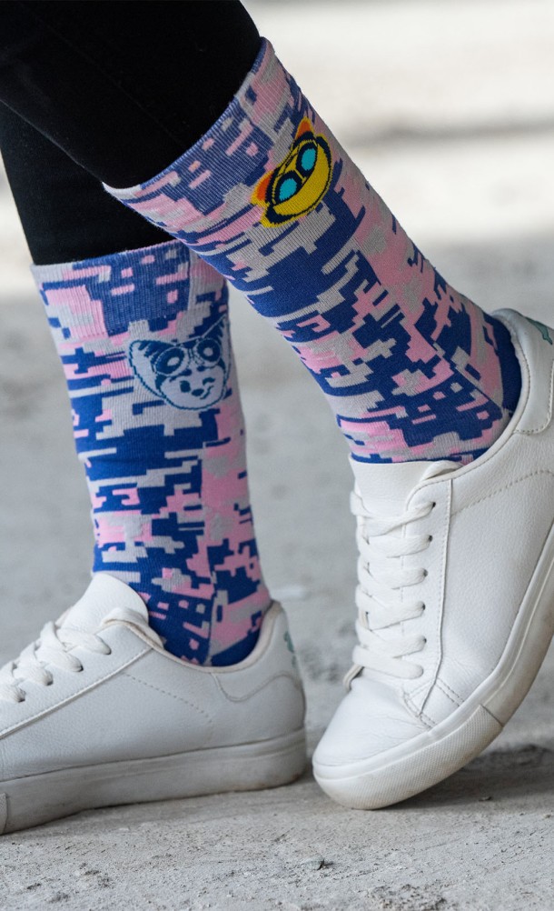 Model wearing the Rivet & Kit Pixel socks from our Ratchet & Clank collection