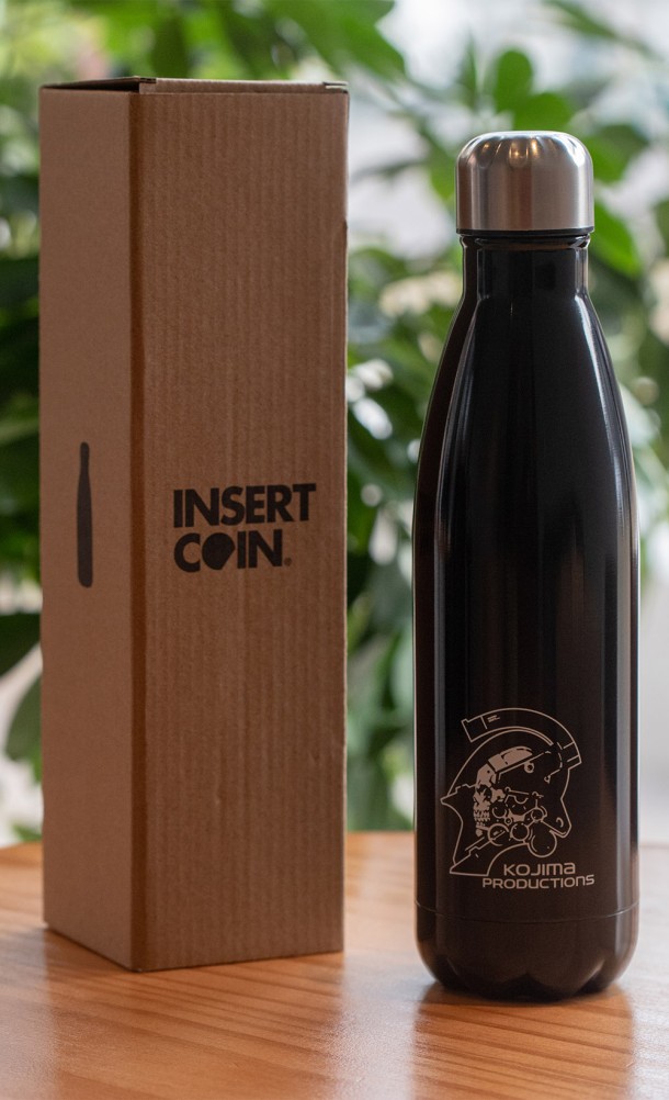 Image of the Kojima Productions Water Bottle in black with packaging box from our Kojima Productions collection