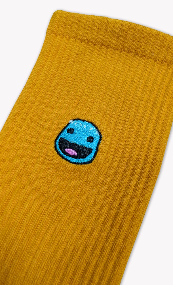 Close up detail on the print of the Sackboy Feel's socks in Gold from our Sackboy collection