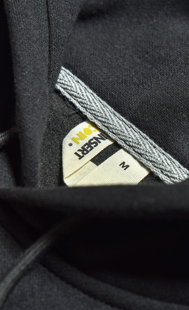 Close up detail on the hang tag of the WASD hoodie from our WASD collection