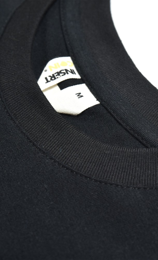 Close up detail on the hang tag of our WASD Pocket T-Shirt from our WASD collection