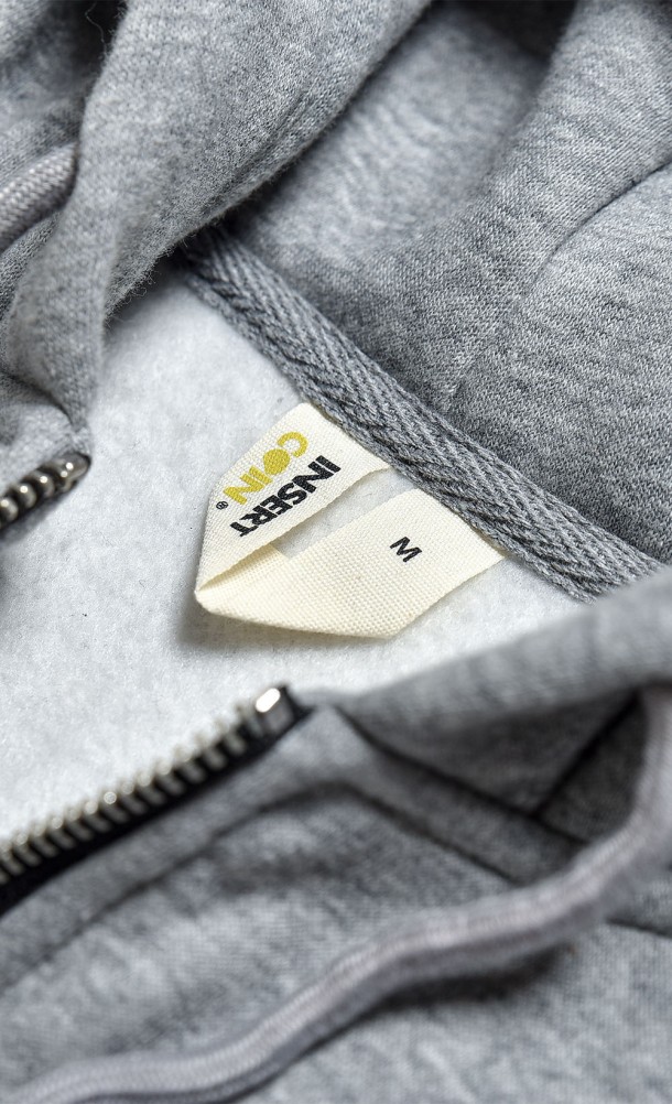 Close up detail on the hang tag of the WASD ZipThru Hoodie from our WASD collection