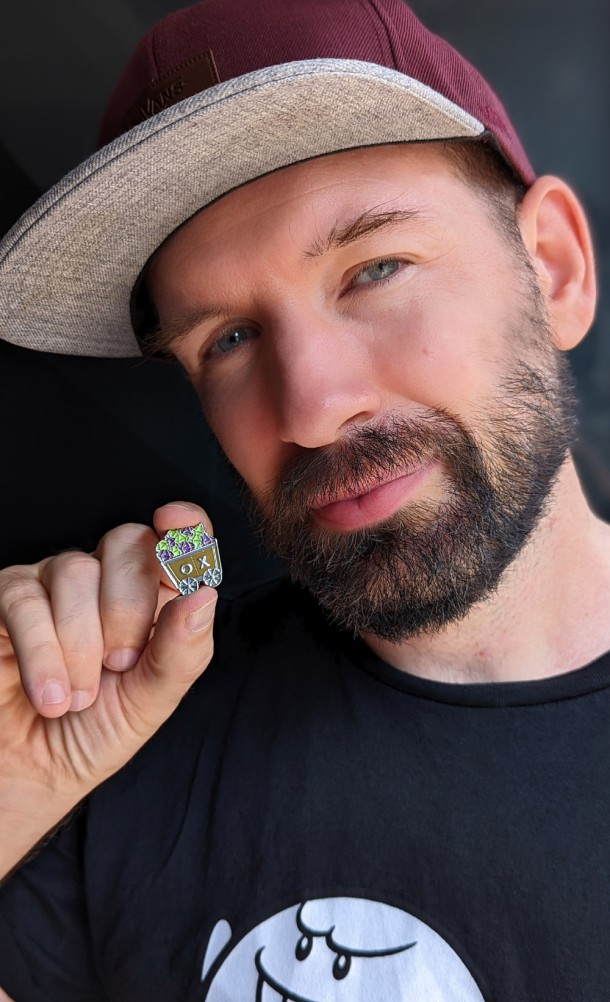 Model showing the Down the Video Mines Enamel Pin from our Outside Xbox / Outside Xtra collection