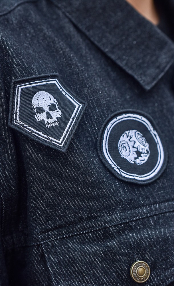 Close up detail of the patches on the Dbd Denim jacket from our Dead by Daylight collection