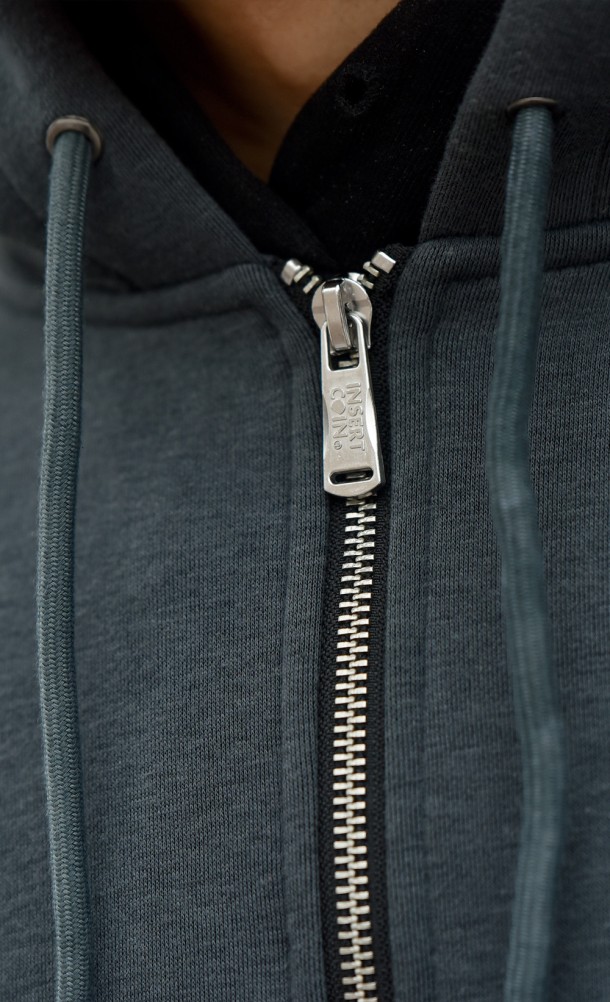 Close up detail of zip on the Generator Repairs hoodie from our Dead by Daylight collection