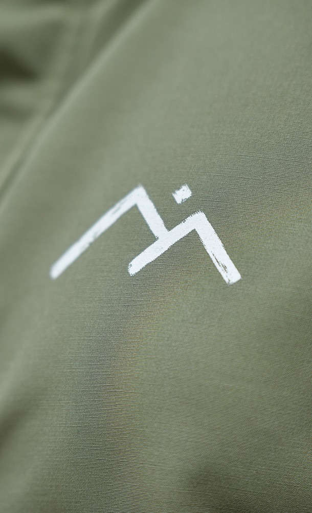 Close up detail on the front print of the New Heights Weatherproof jacket from our Horizon Call of the mountain collection